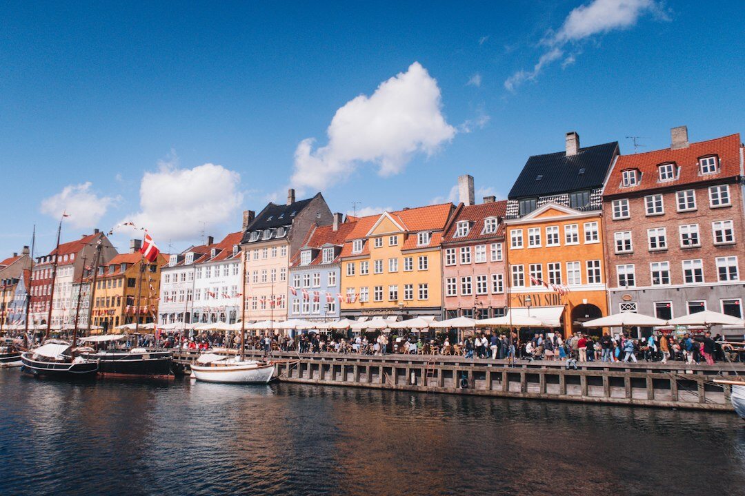 Colorful row of traditional Danish townhouses along a canal in Nyhavn Copenhagen
